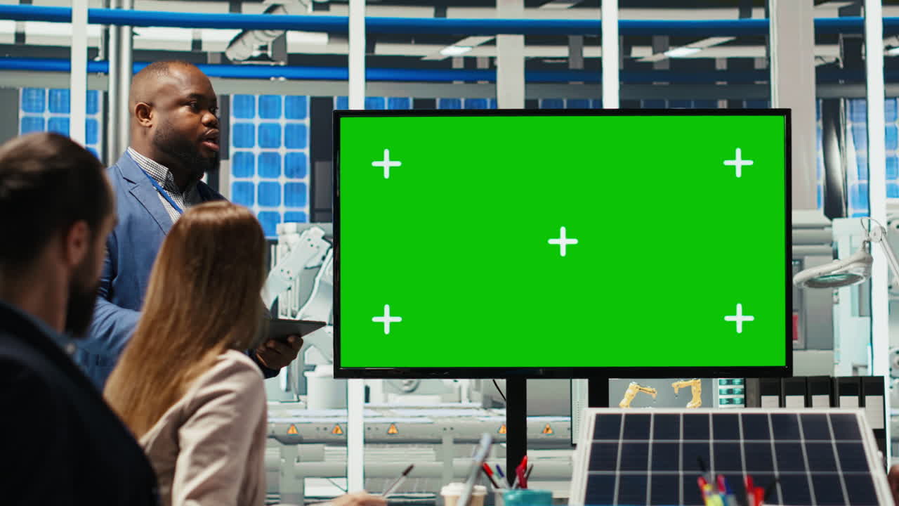 Managers In Office Reviewing Solar Technology Reports On Green Screen Monitor