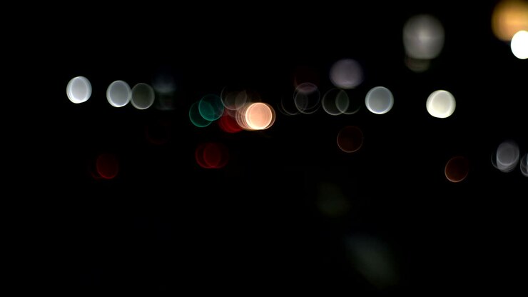 Defocused and blurry car driving traffic in Bangkok street on night time,high noise and beautiful bokeh.