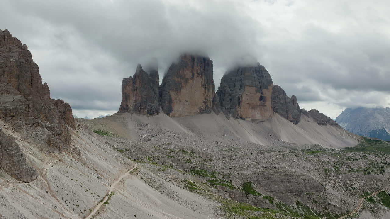Panoramic drone shot of Tre Cime di Lavaredo in Dolomites, Italy on a cloudy day