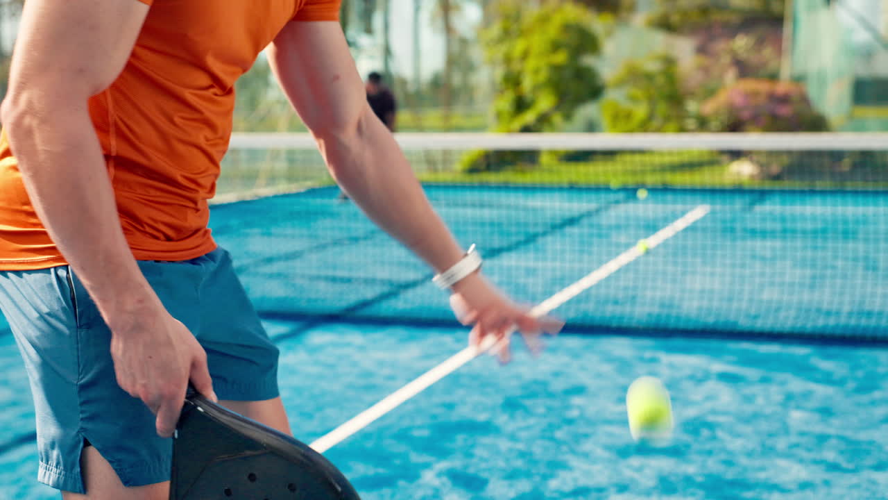 Man Playing Padel Tennis on a Blue Outdoor Court