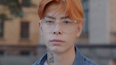 young man with red hair and glasses