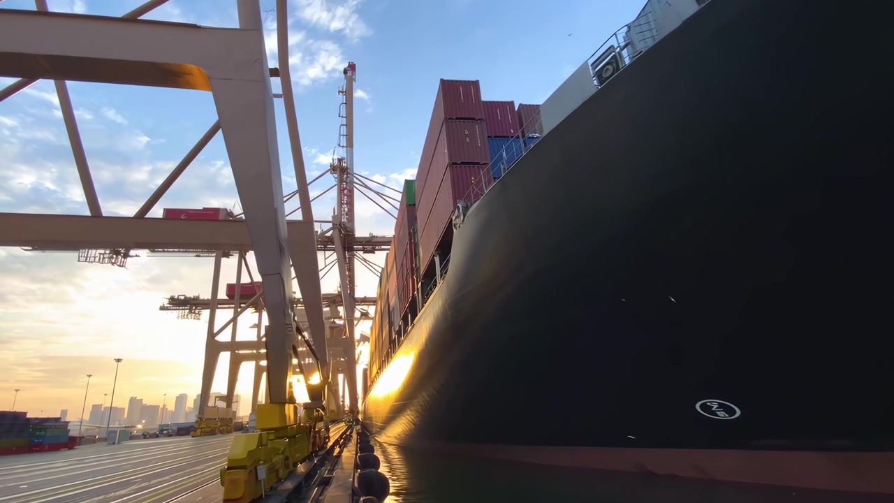 Large Container Ship Being Loaded at Port During Sunset