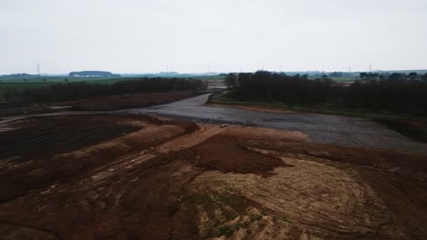 Slow-panning-shot-of-a-construction-site-ground-needing-work-to-build-houses