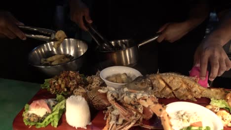 putting food on platter with fish