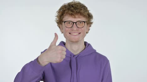 thumbs up by redhead young man, white background