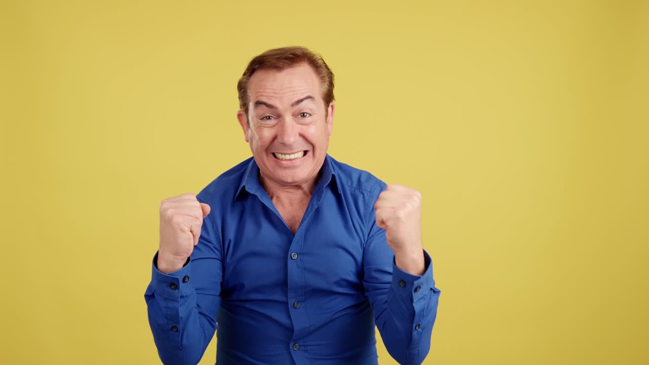 A man expressing extreme excitement and triumph