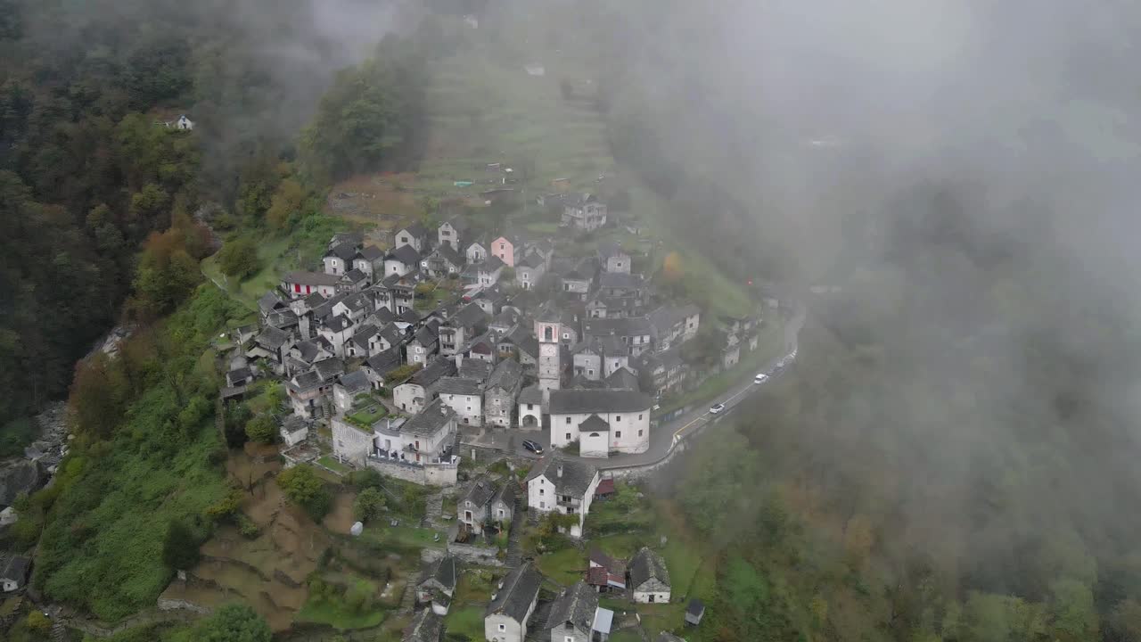 Drone footage of the iconic town of Corippo, Valle Verzasca, Switzerland, with a foggy charm.