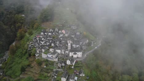 drone footage of the iconic town of corippo, valle verzasca, switzerland, with a foggy charm.