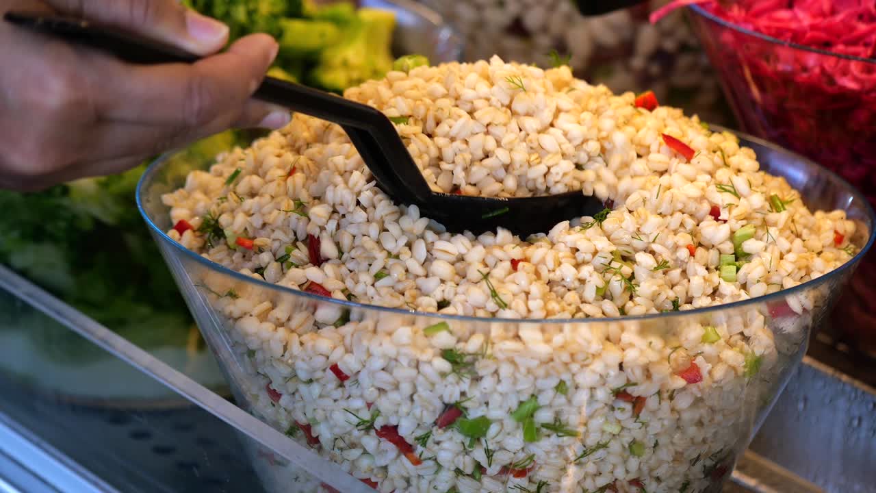 Serving a Fresh Barley Salad at a Buffet