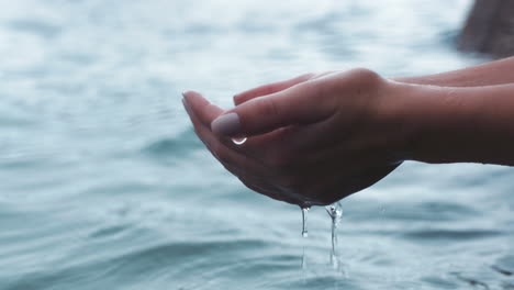 Beach-water,-travel-and-hands-in-sea-during