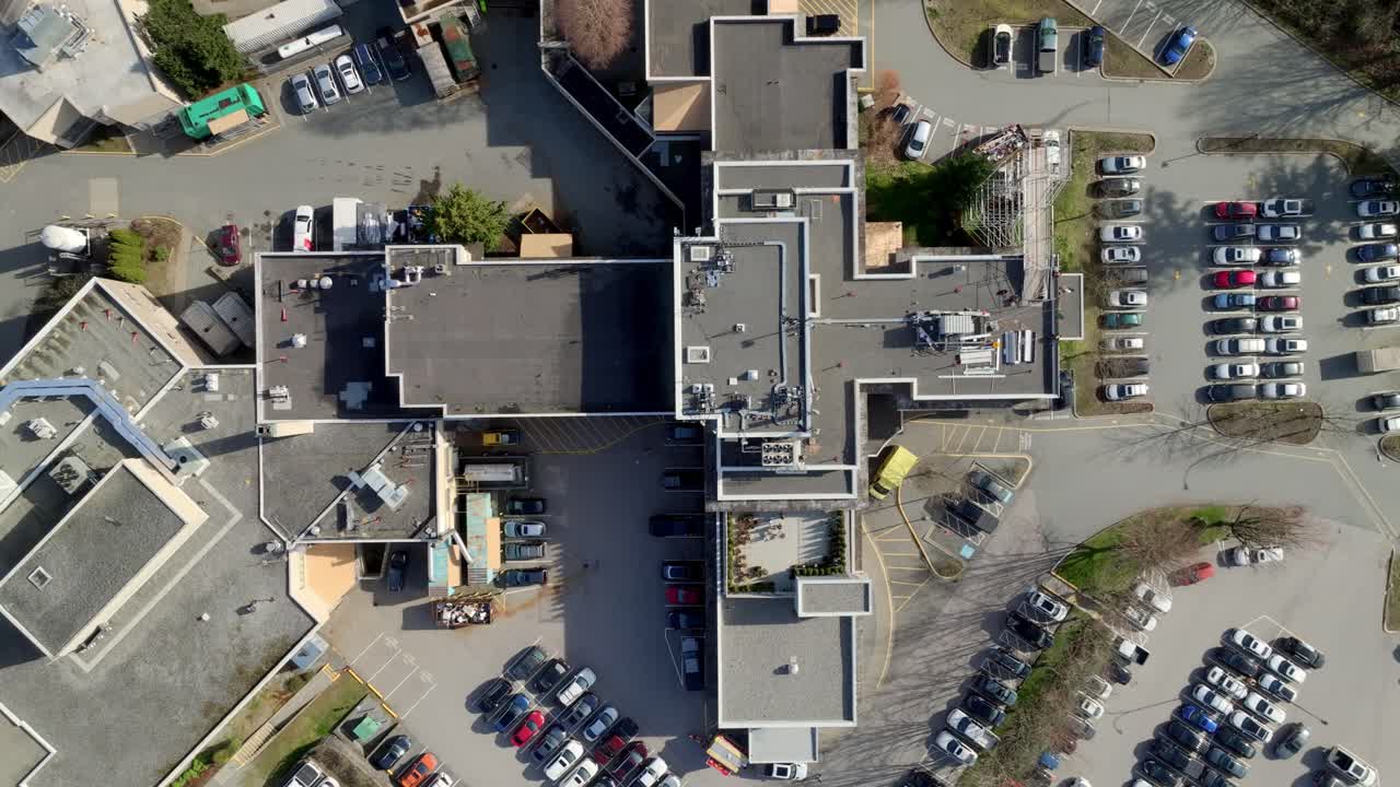 Mission Memorial Hospital Features a Cross-shaped Layout and is Surrounded by Busy Parking Lots, Located in Mission, British Columbia, Canada - Aerial Topdown Shot