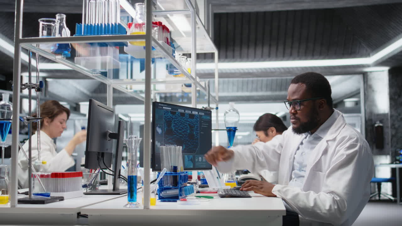 Vertical video Quality control analyst in laboratory analyzing solution at workstation using PC