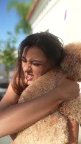 woman hugging and kissing a dog