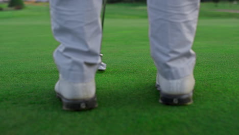 golf player stand fairway on grass lush course. active man swinging club outside