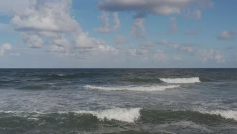 up close aerial of waves as the break towards the shore