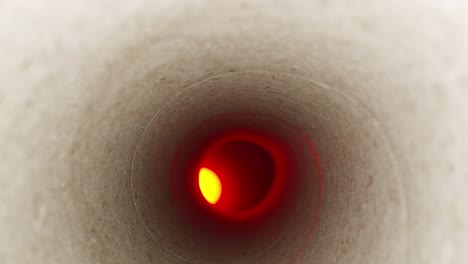 detailed macro of fibers in the tube, moving deep inside a paper towel tube with an offset red light at the end