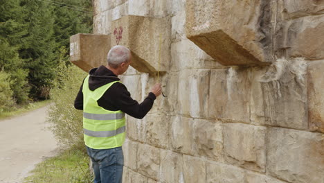 worker inspecting stone bridge