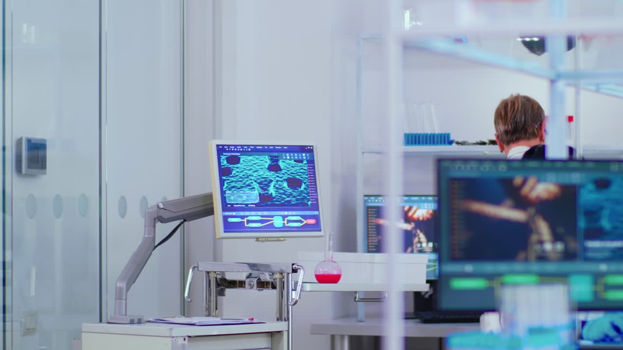 Black young scientist working in busy modern laboratory