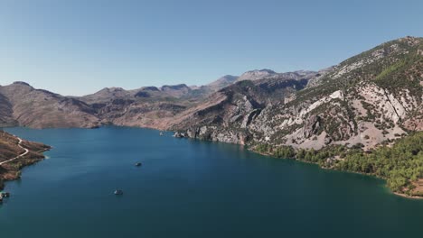 boast anchored in blue waters of beautiful green canyon, taurus mountains turkey