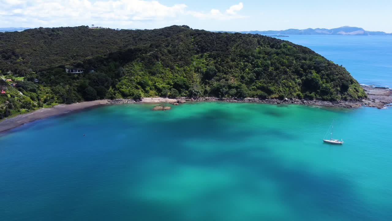 AERIAL Side Panning Shot of a Boat and a Gorgeous Blue Bay in Northland, New Zealand