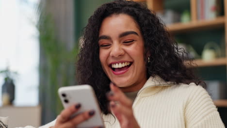 woman with curly hair using a phone indoors