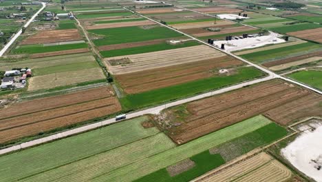 farming lands with different plantations and fuel lorry driving through