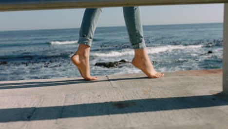 woman legs walking barefoot on seaside pier balancing teenager enjoying summer vacation in beautiful ocean background