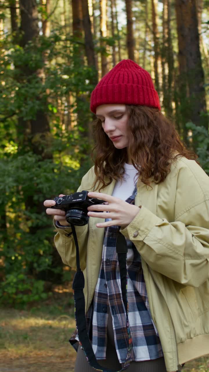 Woman taking photo in the forest