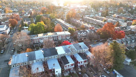 aerial tilt up reveals sunrise over suburban town on outskirts of american downtown urban city