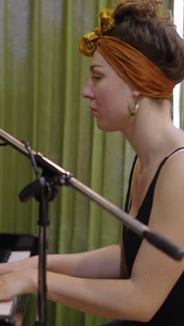 woman playing piano with headband and microphone