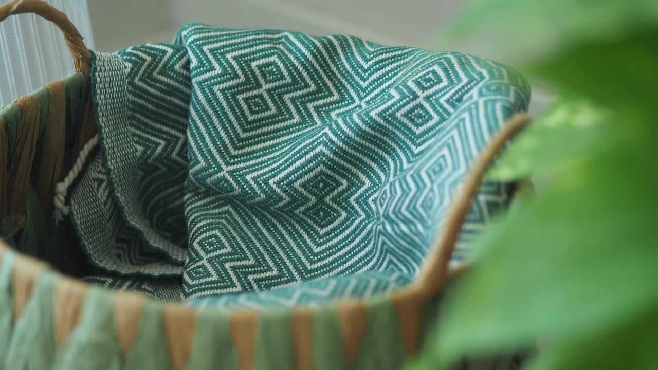 Close-up of a woven basket with a green patterned cloth