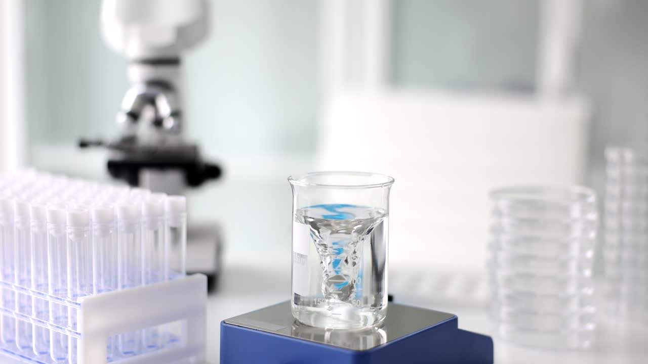 Laboratory equipment including beaker, test tubes and microscope