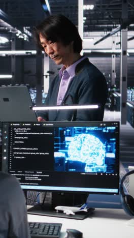 vertical video team leader supervising technicians in server room using ai