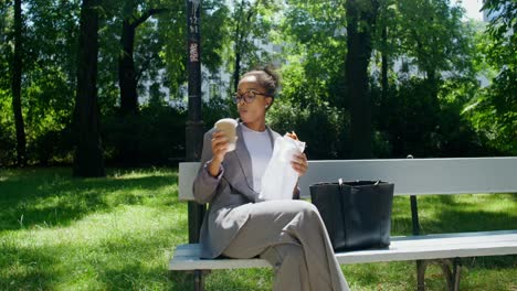 businesswoman having lunch in the park