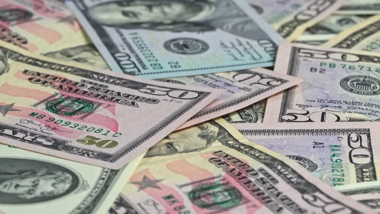 Bills of different denominations scattered on a table