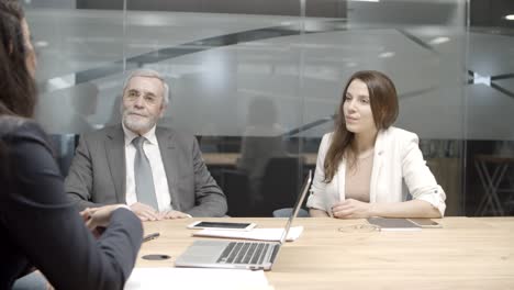 focused business team listening to speaker in conference room