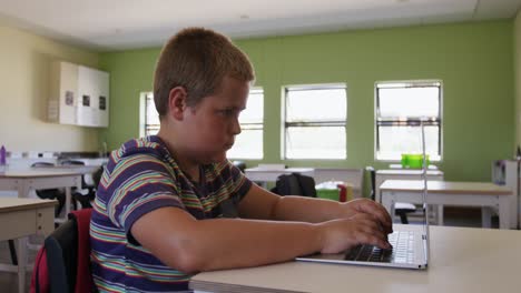 Boy-using-laptop-in-the-class