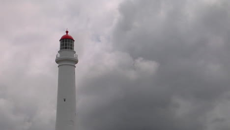 a lighthouse stands ready in the murk of an overcast day