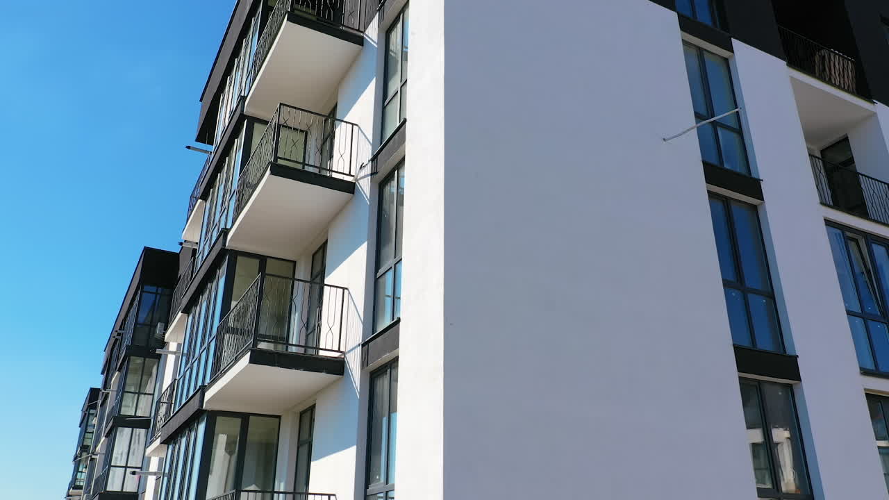 Newly built modern apartment building facade. Exterior of multi storey building. Modern design of urban architecture. Aerial view.