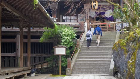 the video captures visitors ascending the stone steps within the grounds of ishiyama-dera temple, shiga, japan, reflecting the serene and spiritual atmosphere of the temple.
