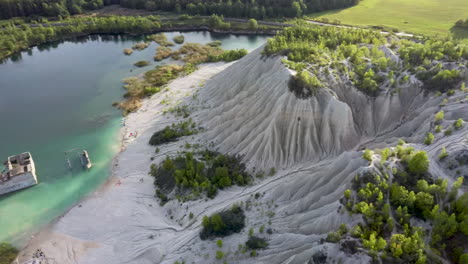 Aerial-landscape-Sand-Hills-of-Quarry-With-a-Pond-and-Abandoned-Prison-in-Rummu-Estonia-Europe