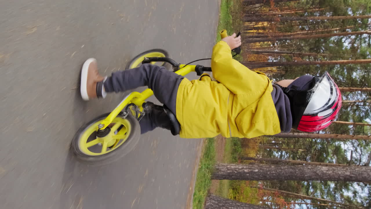 Boy Riding Balance Bike in Park