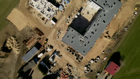 sitio de construcción de edificios de varios pisos en lubawa, polonia drone volando lentamente hacia adelante mostrando el progreso de la construcción desde la vista superior