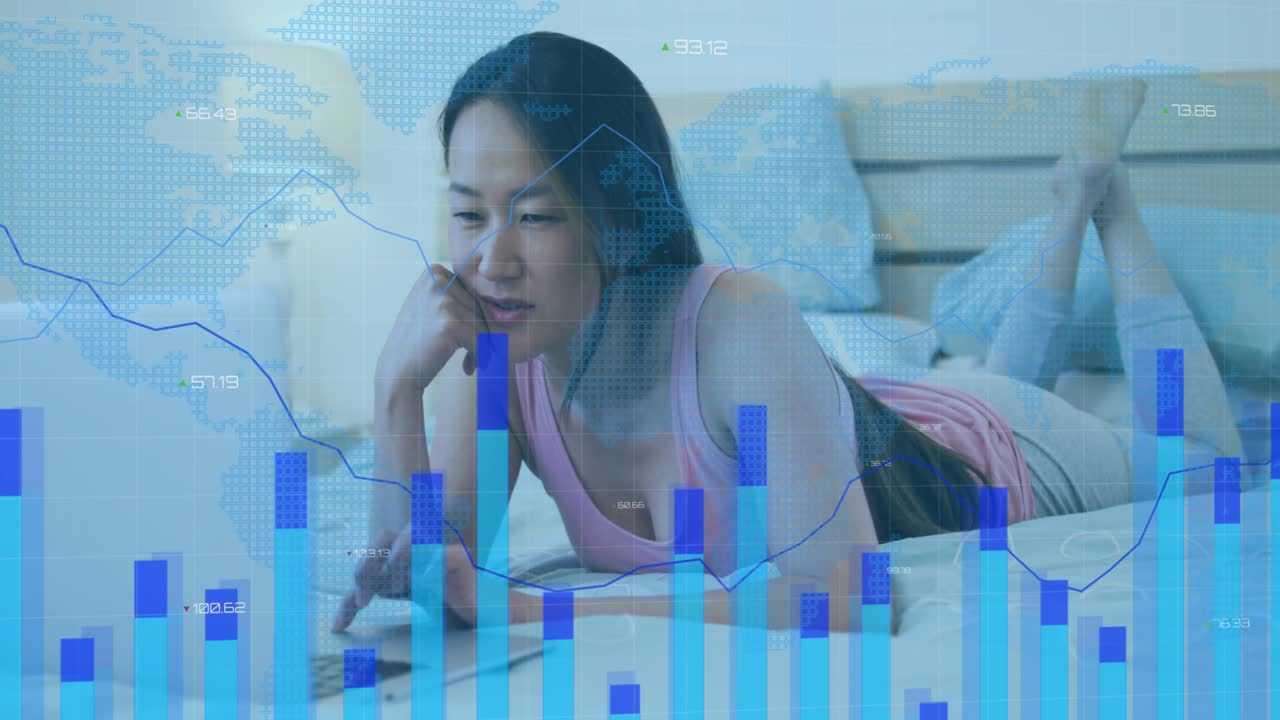 Mid adult woman tapping laptop trackpad on bed, animating tech bar charts visualizing trends