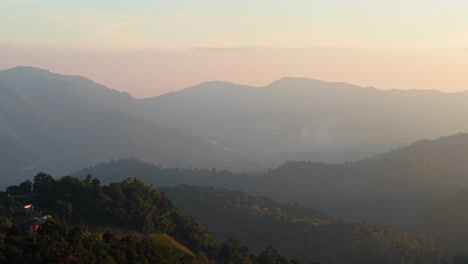 misty mountain range at sunrise/sunset
