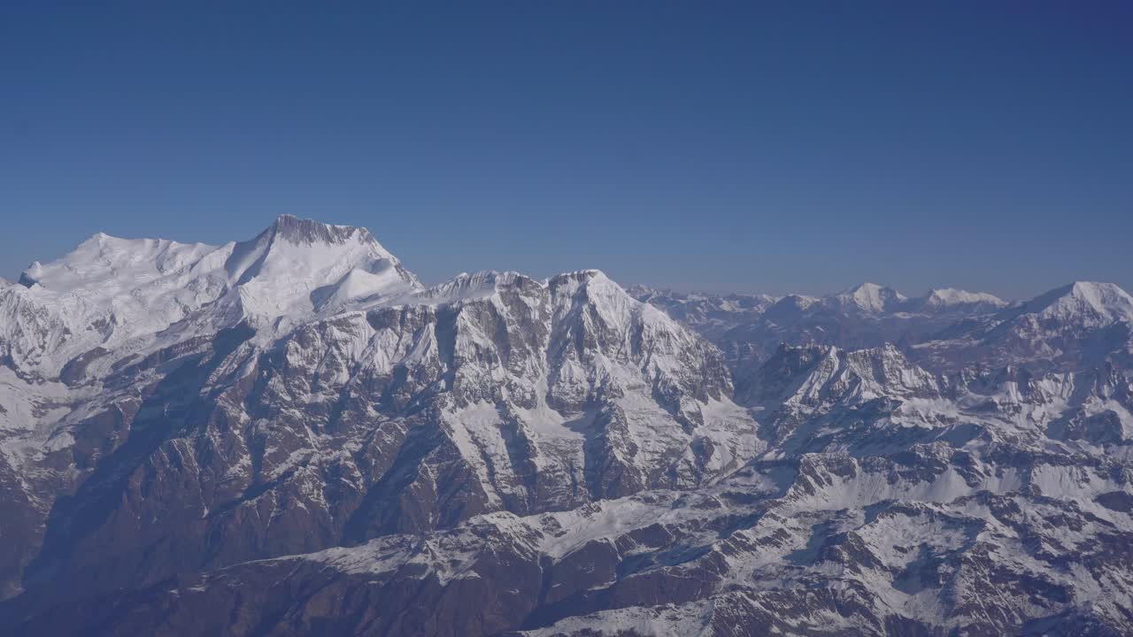 High-altitude view of Himalayan mountains in Nepal seen from a mountain flight, highlighting snow peaks and natural grandeur