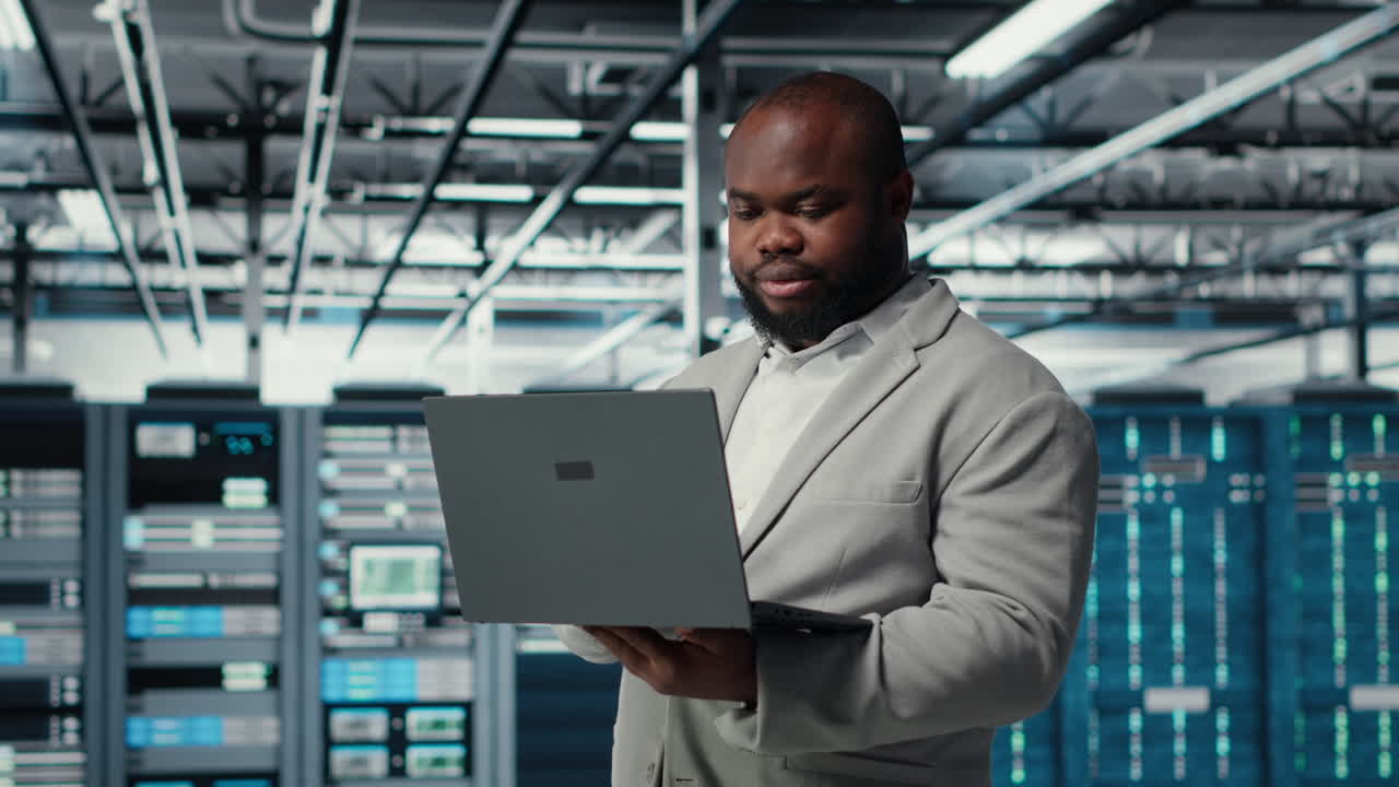 Vertical video Engineer in data center using laptop to update storage arrays