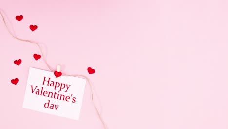 happy valentine's day text appear on paper hooked on rope. romantic stop motion