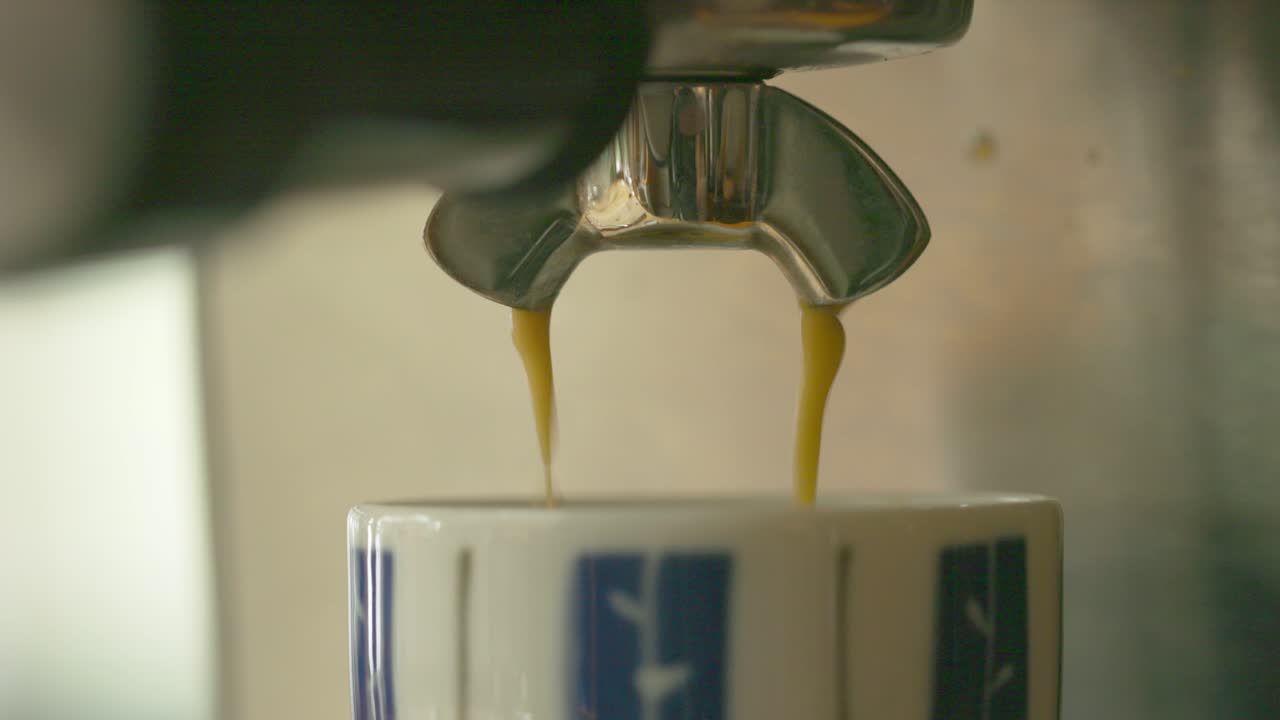 Coffee machine serving freshly brewed liquid in a cup inside the restaurant shop