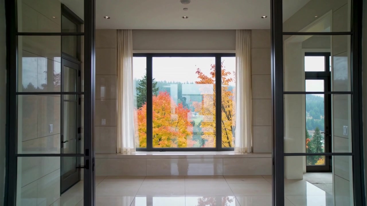 Sliding glass doors opening outward after nudge in foyer, revealing picture window, autumn trees